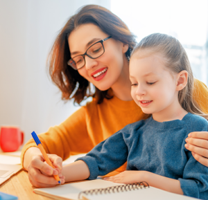 Child participating in a home-based learning activity with an adult